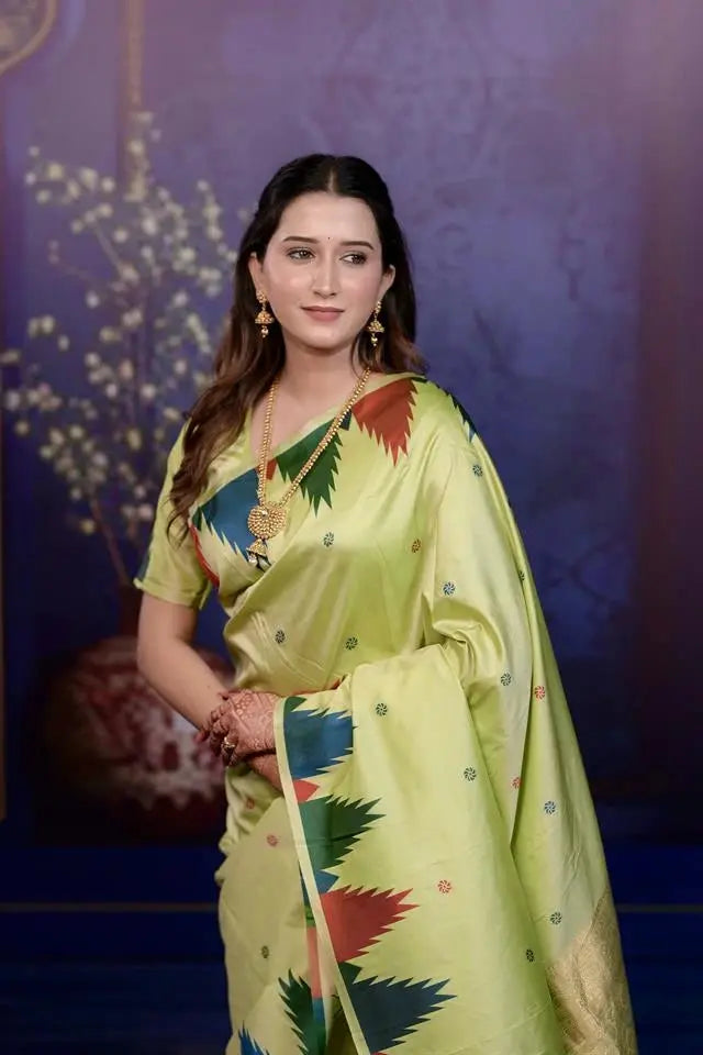 Woman in a colorful saree against a blue background